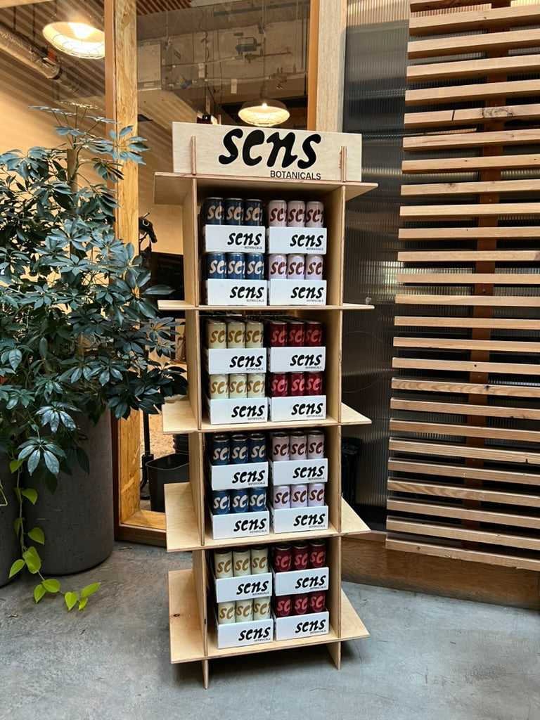 A wooden Sens display stacked with all four blends